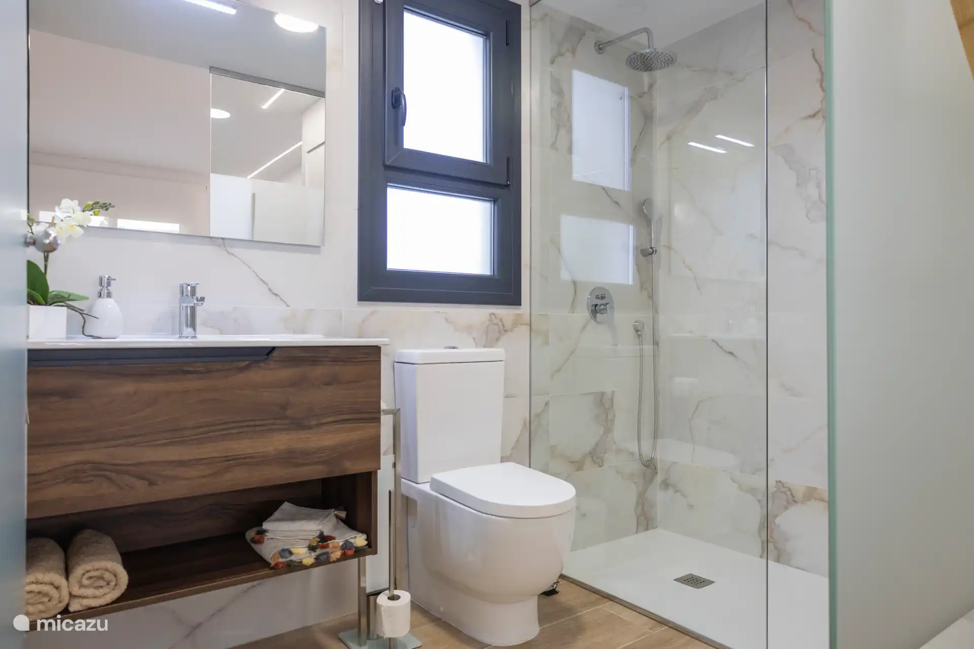 The luxurious ensuite bathroom with bath linen and hair dryer.