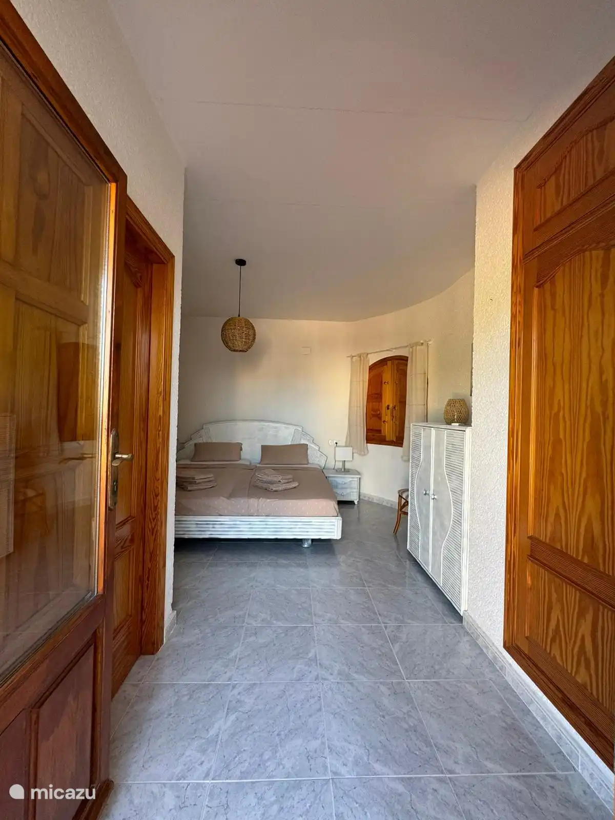 bedroom with adjoining bathroom and roof terrace upstairs