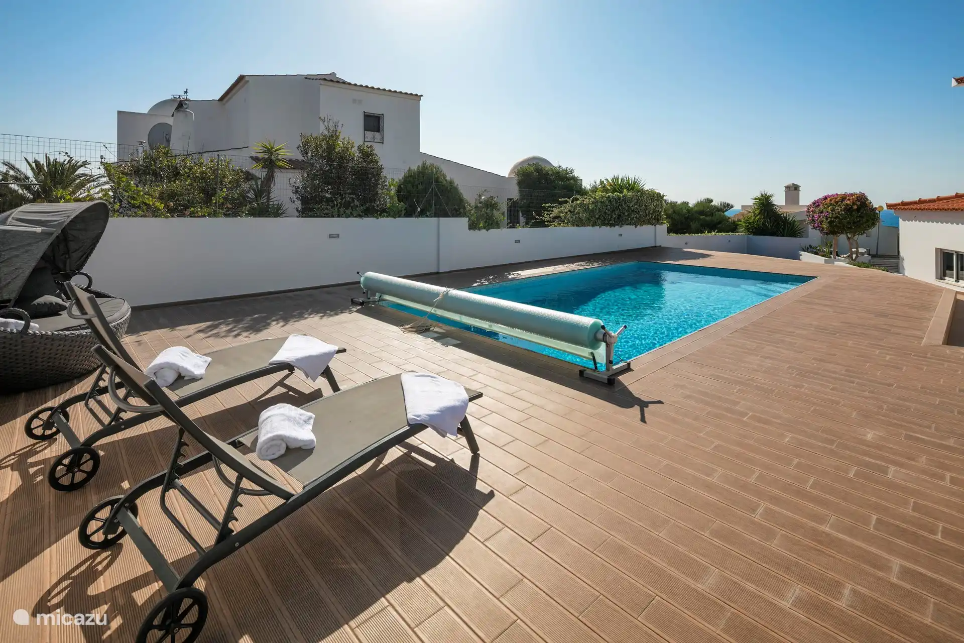 Swimming pool with sun loungers
