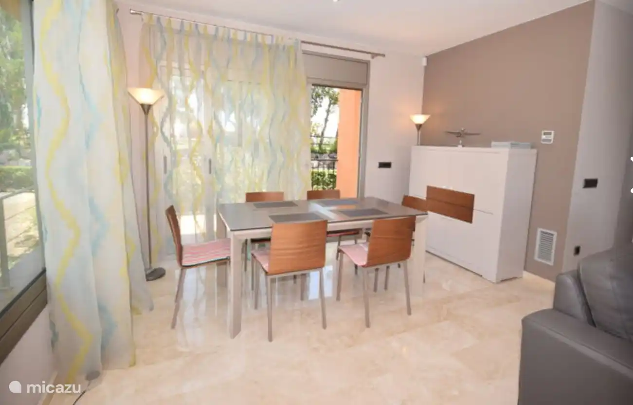 Esstisch mit Schiebetüren zur zweiten Terrasse mit Blick auf den Garten und den Pool