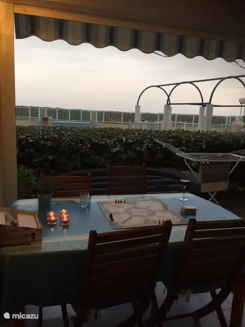 The terrace overlooking the pool and behind it the sea