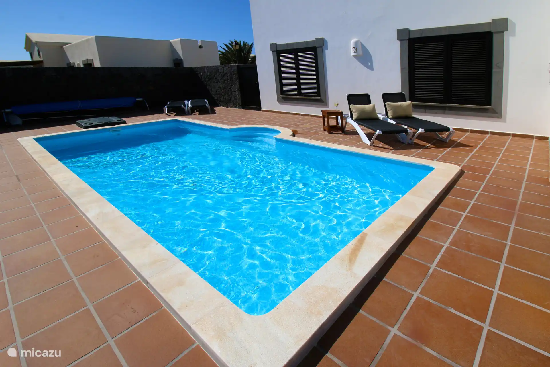 The nice swimming pool with sunbeds