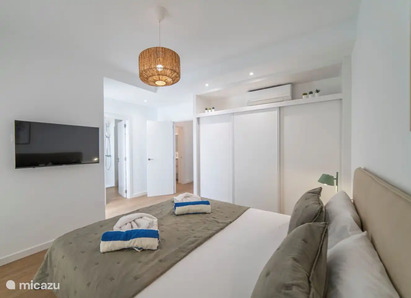 Bedroom 1 with double bed, air conditioning and en-suite bathroom. 