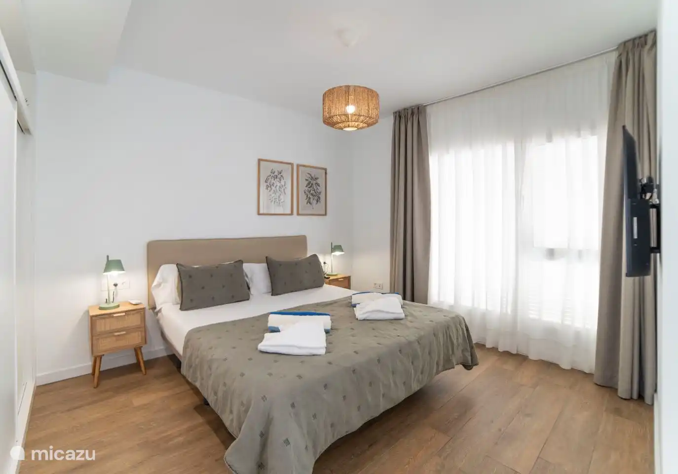 Bedroom 1 with double bed, air conditioning and en-suite bathroom. 