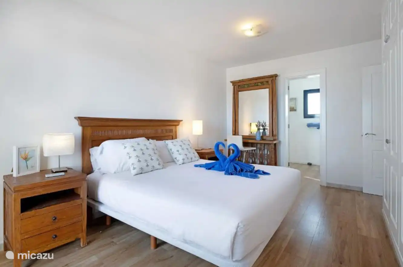 Bedroom 1 with a double bed, fitted wardrobes and an adjoining bathroom