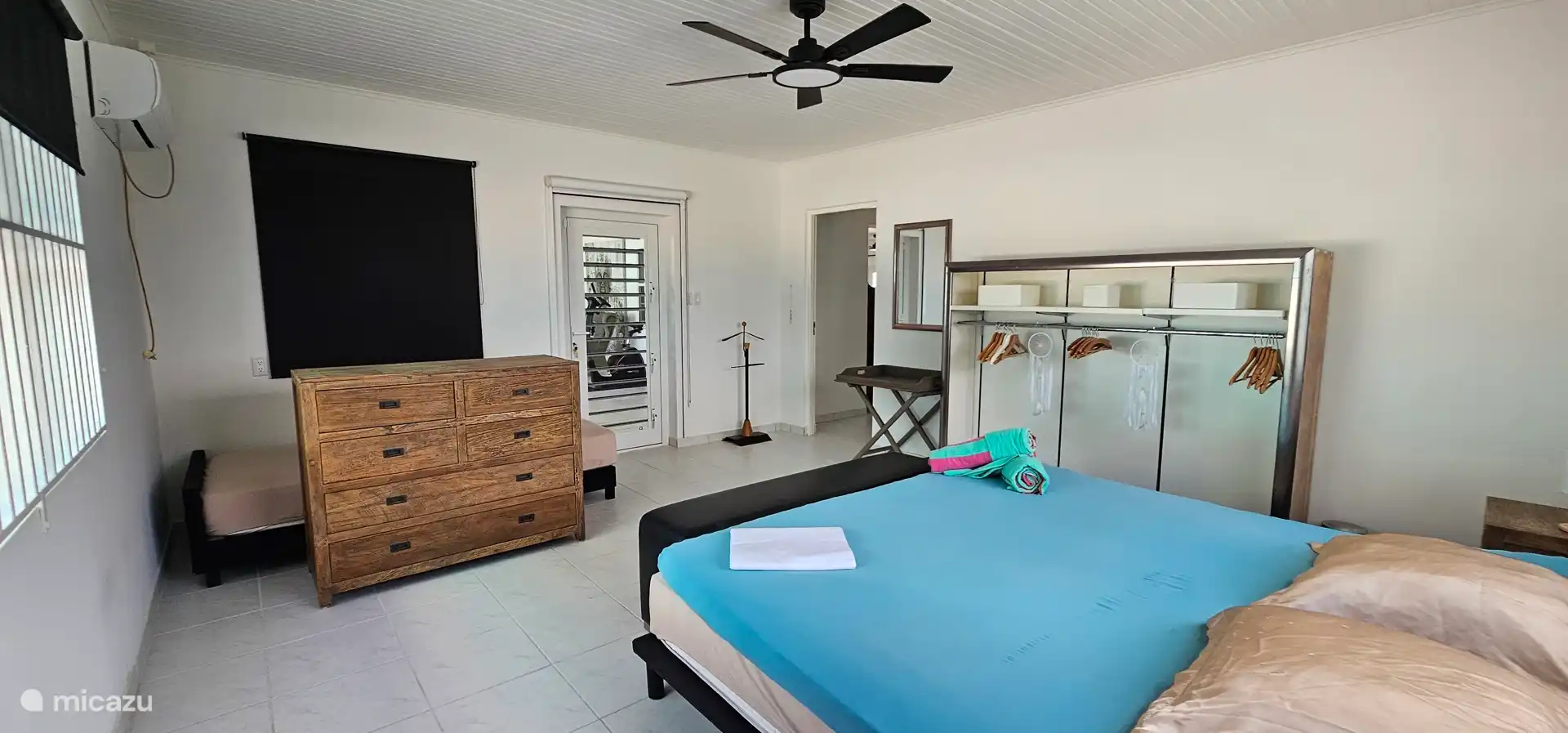 Bedroom 2 downstairs. Direct access to the porch and swimming pool.