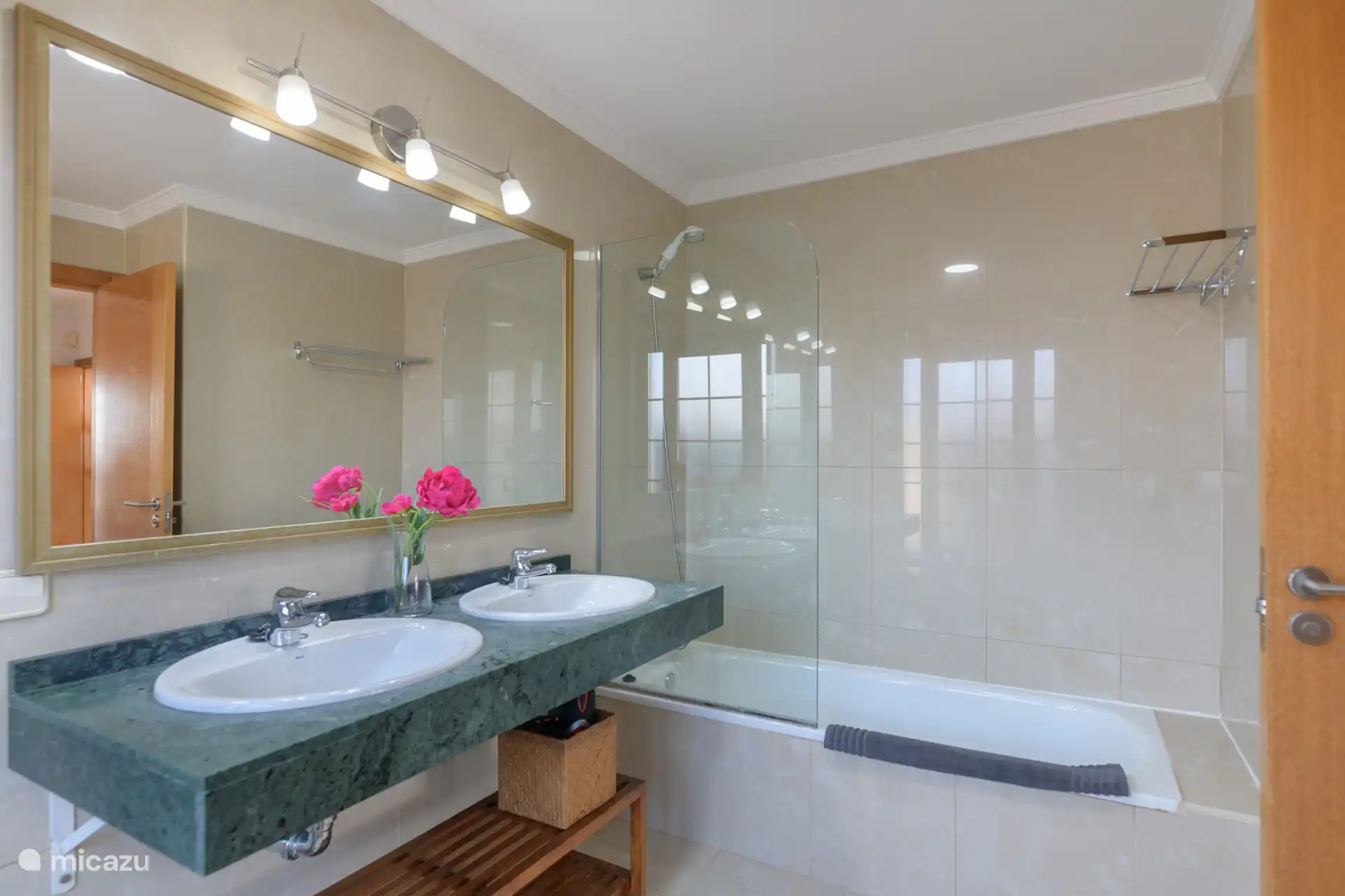 Bathroom 1 with a toilet, bidet, double sink and a shower in bath