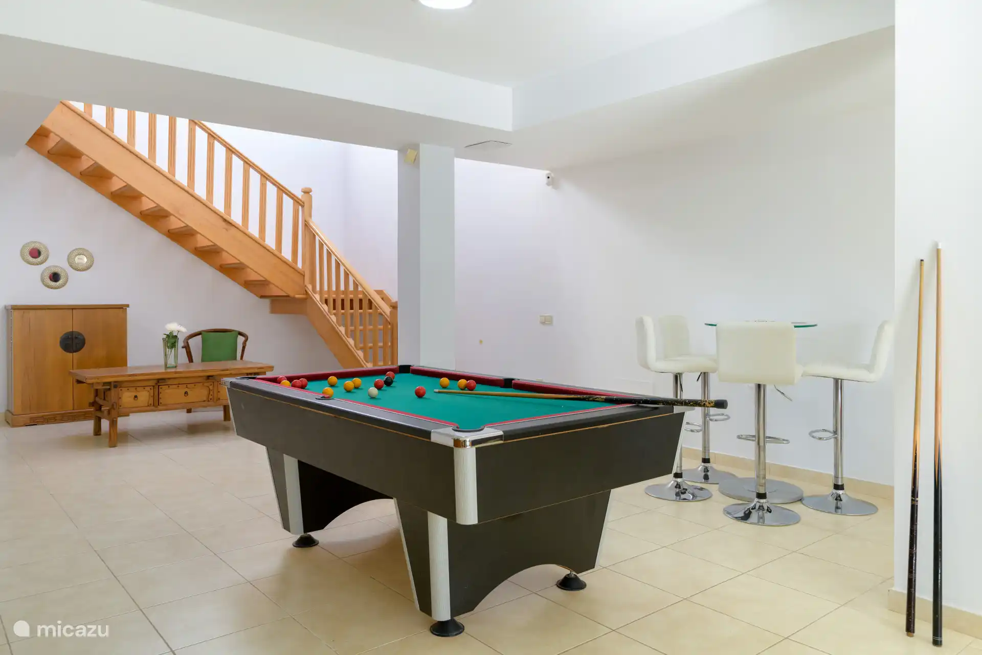 The basement has a nice sitting area and a billiard table