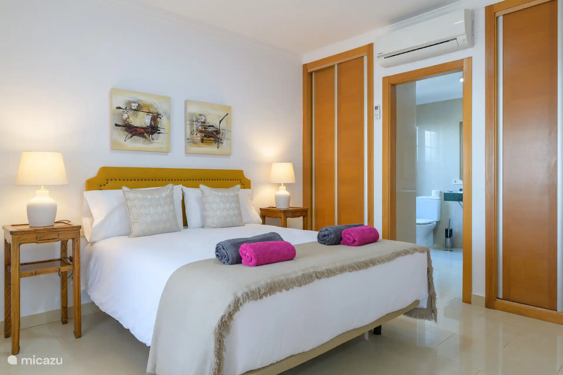 Bedroom 2 with an adjoining bathroom and air conditioning