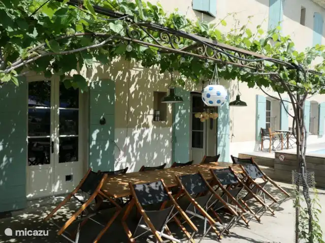 Location vacances St-Anne-caractère | France, Vaucluse, Beaumes-de-Venise - maison de vacances Terrasse. Pergola avec ombre naturelle et table spacieuse pour des moments conviviaux. C’est l’heure de l’apéro !