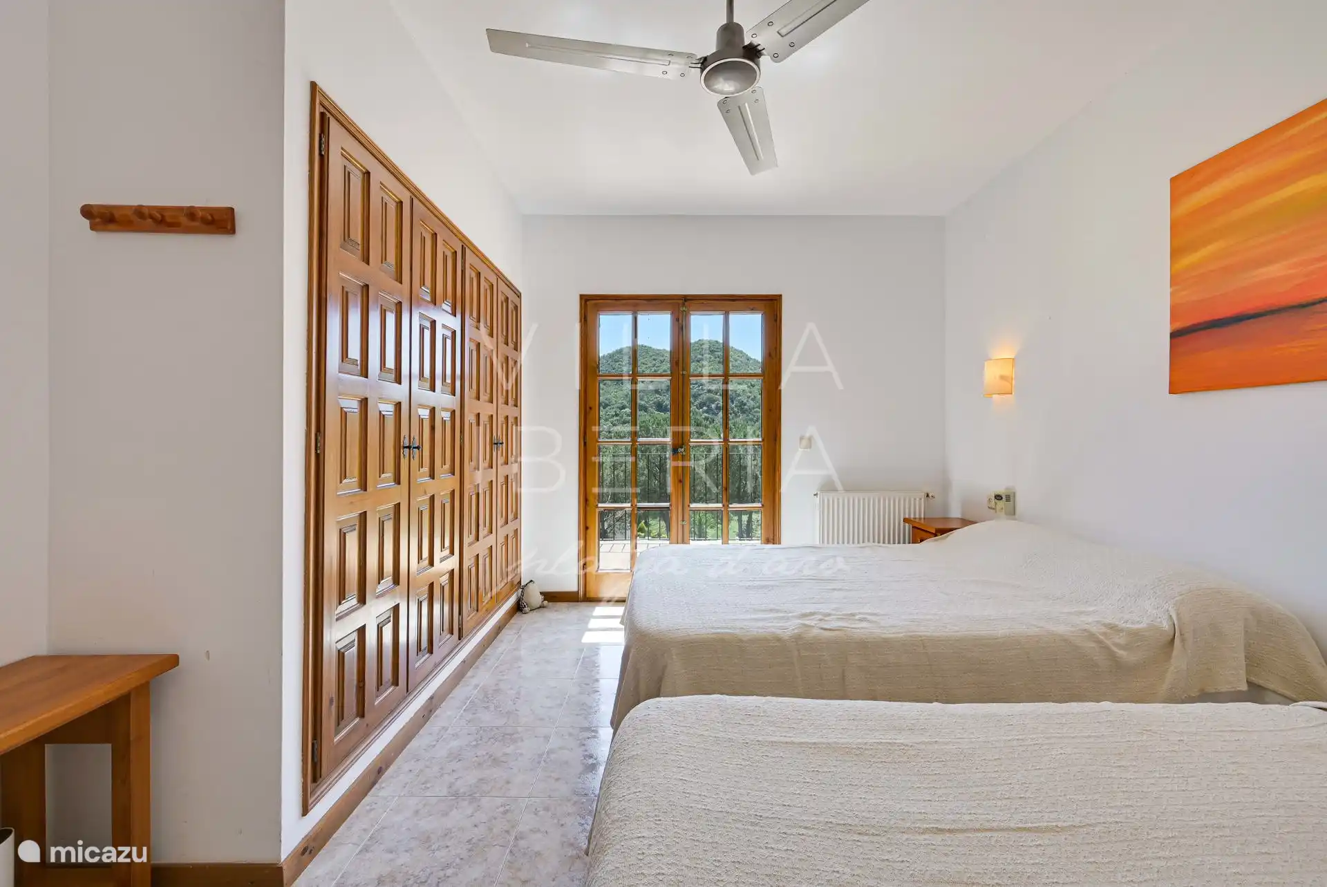 Bedroom 1/4 with patio doors to the balcony