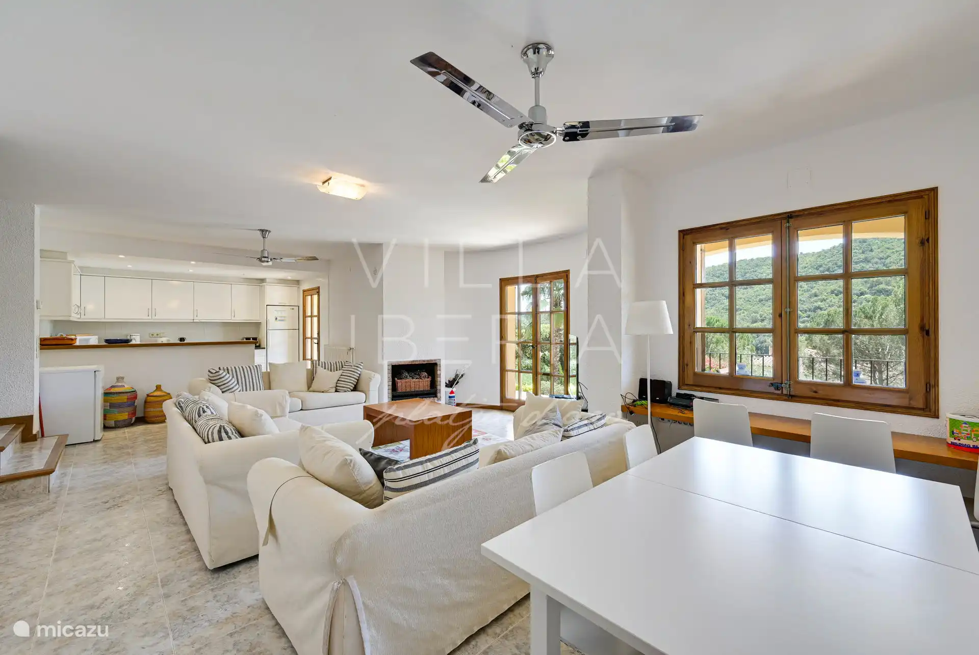 Spacious, open plan living room with direct access to the covered terrace