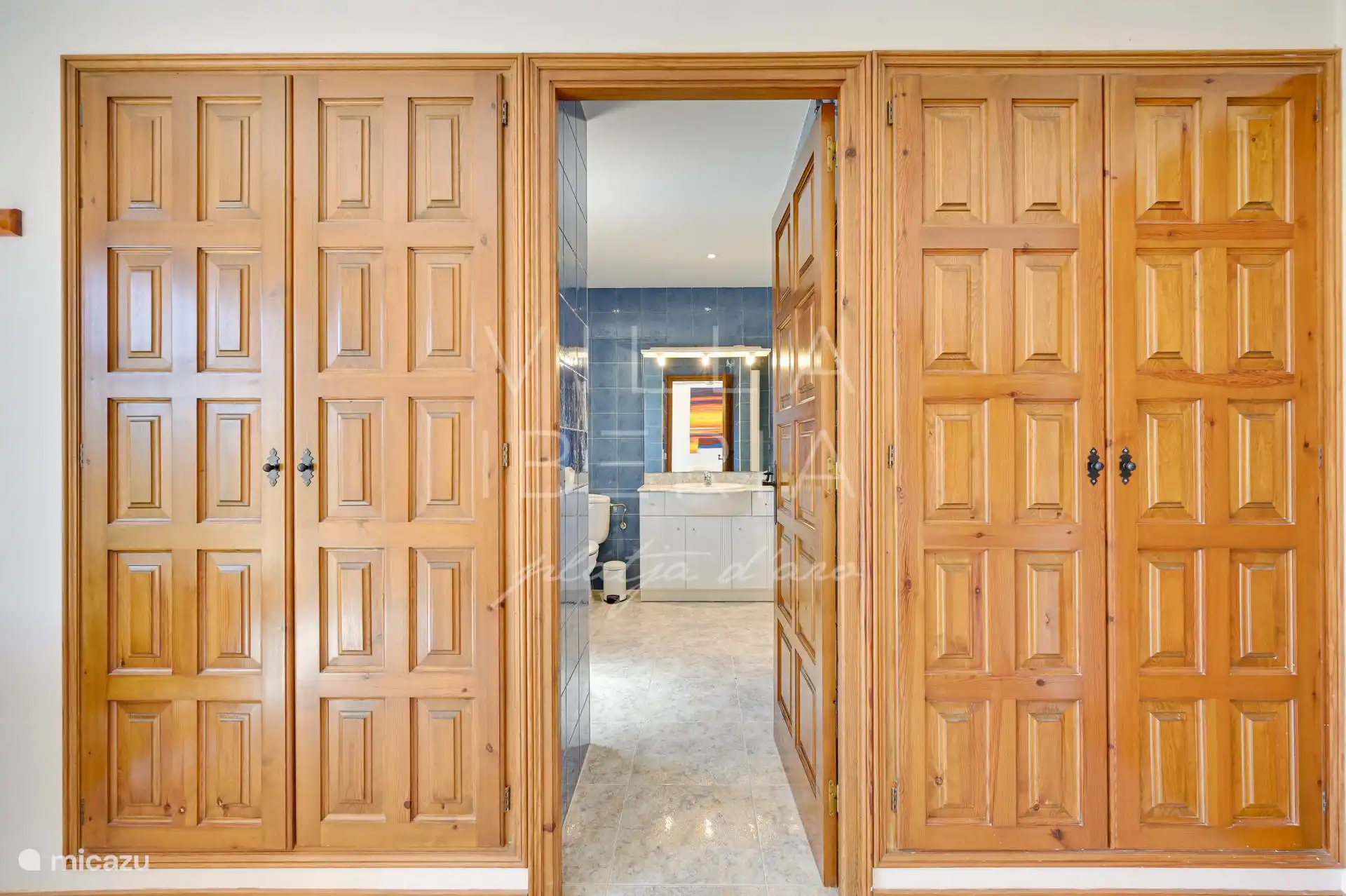 entire wall with fitted wardrobes with passage to en suite bathroom 2/3 belonging to bedroom 2/4