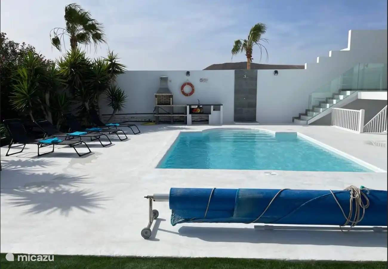 Private swimming pool with salt water and cover.