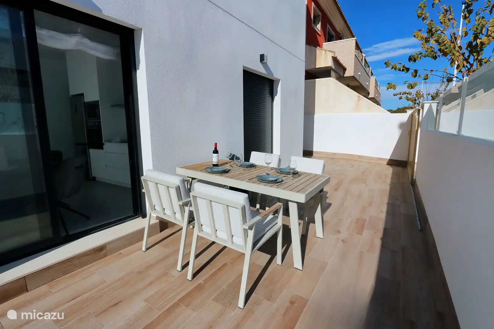 Dining table outside along the house.
