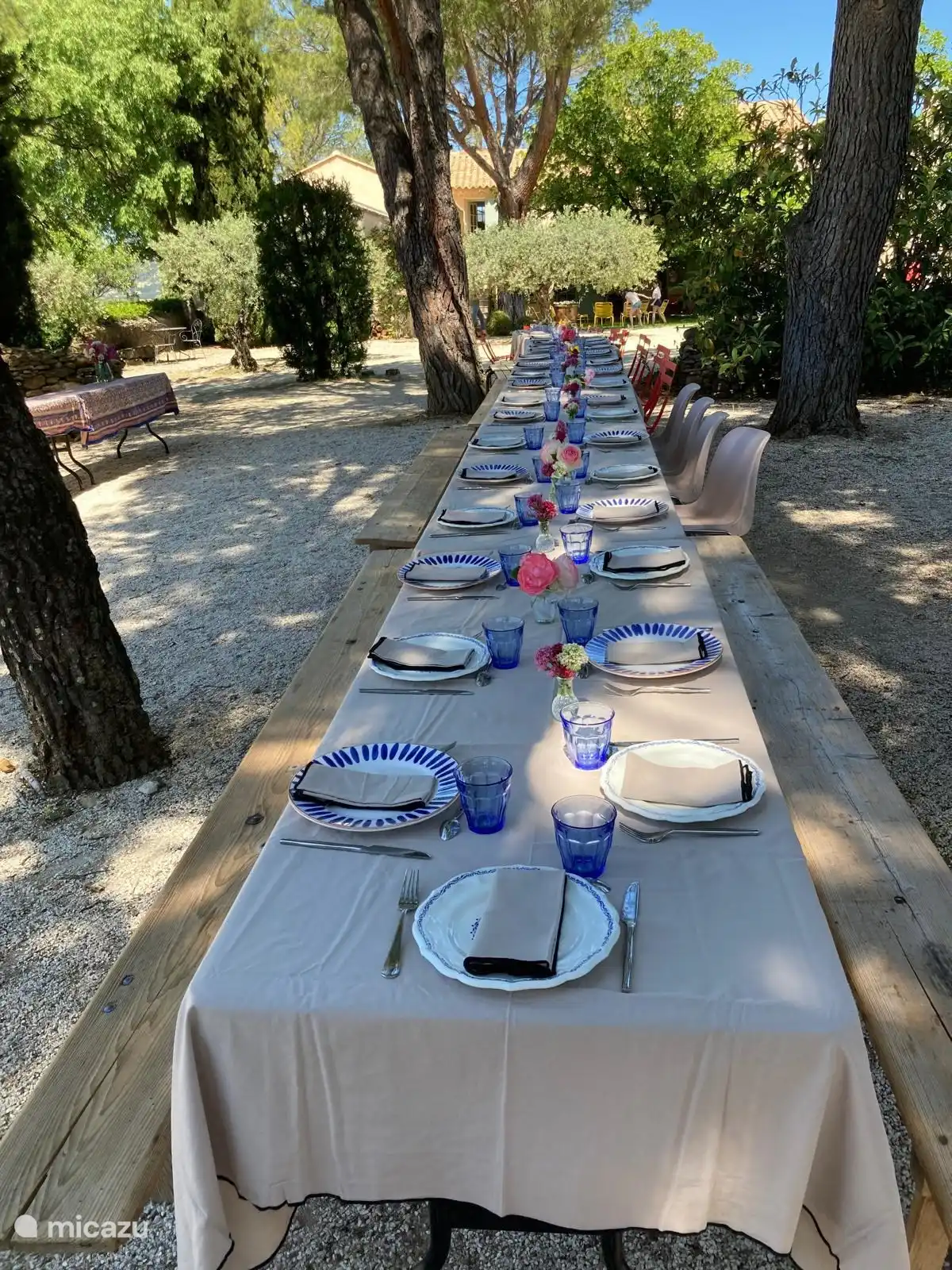 Großer geselliger Tisch im Schatten der Bäume