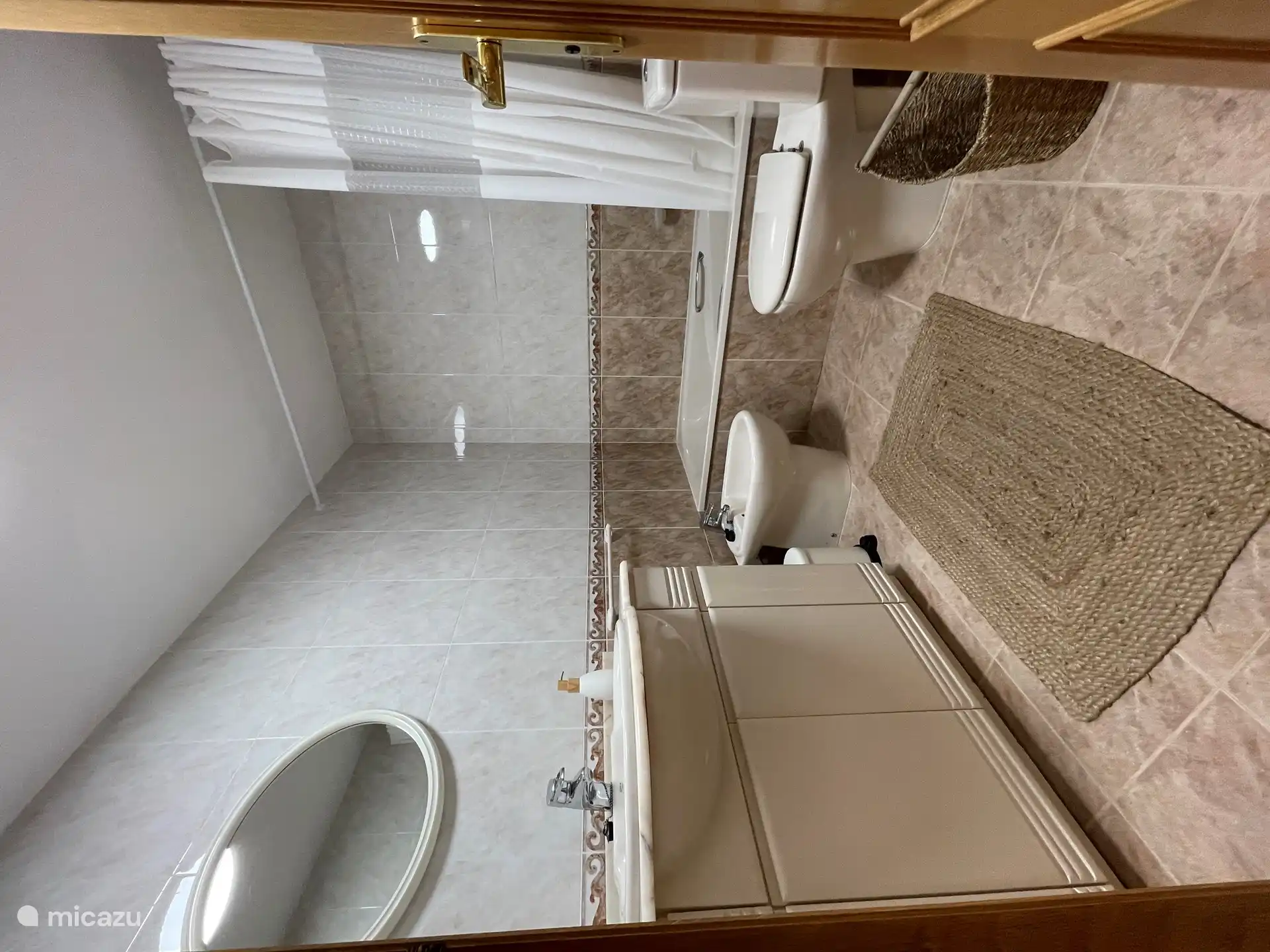 Badezimmer mit Waschbecken, Badewanne/Dusche, WC und Bidet.