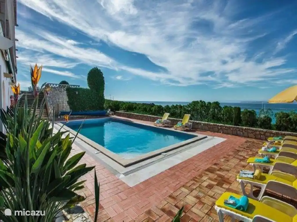 Swimming pool with sun loungers