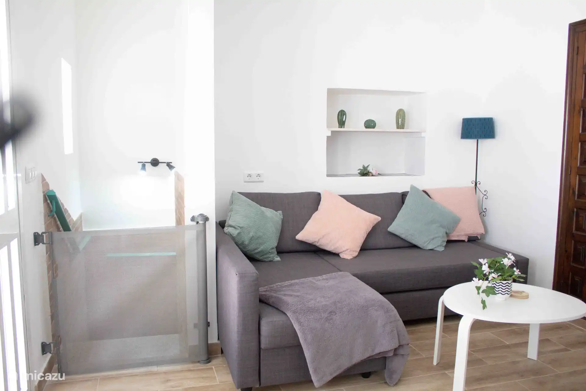 Upstairs lounge room with a couch and tv, leads onto the balcony 
