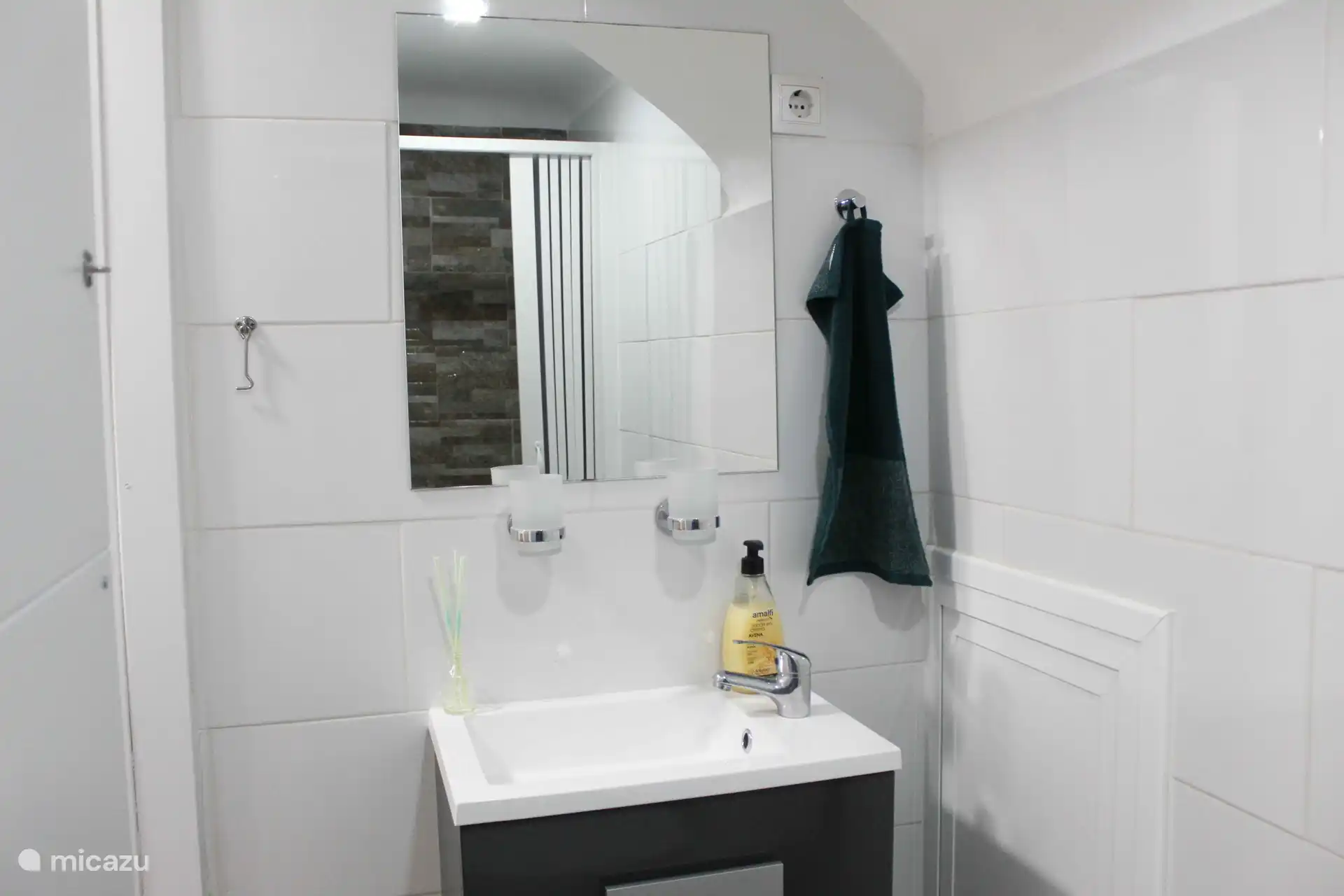 Downstairs backroom with a shower, toilet, and sink 