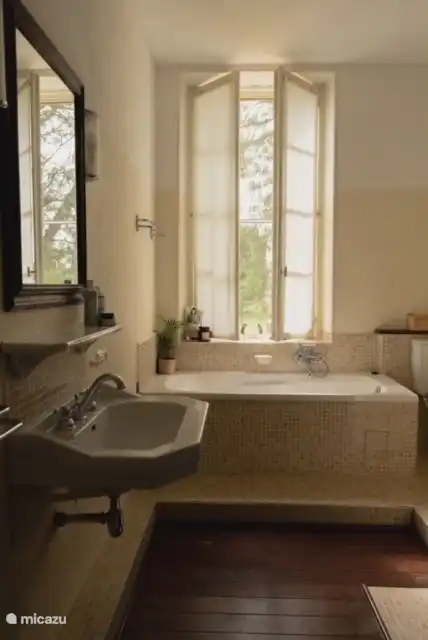 The bathroom in the house with bathtub and separate shower cubicle.