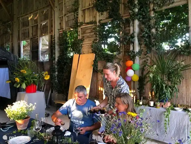 Eating outside at long tables or in the old tobacco barn.