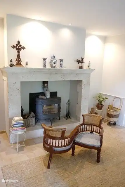 The living room with fireplace and seats.