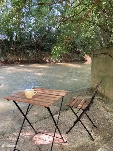 Drinking coffee by the river.