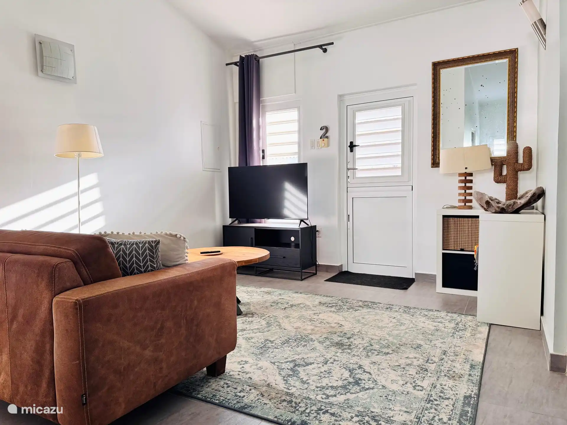 The living room. You have access to a large modern TV screen with streaming apps.