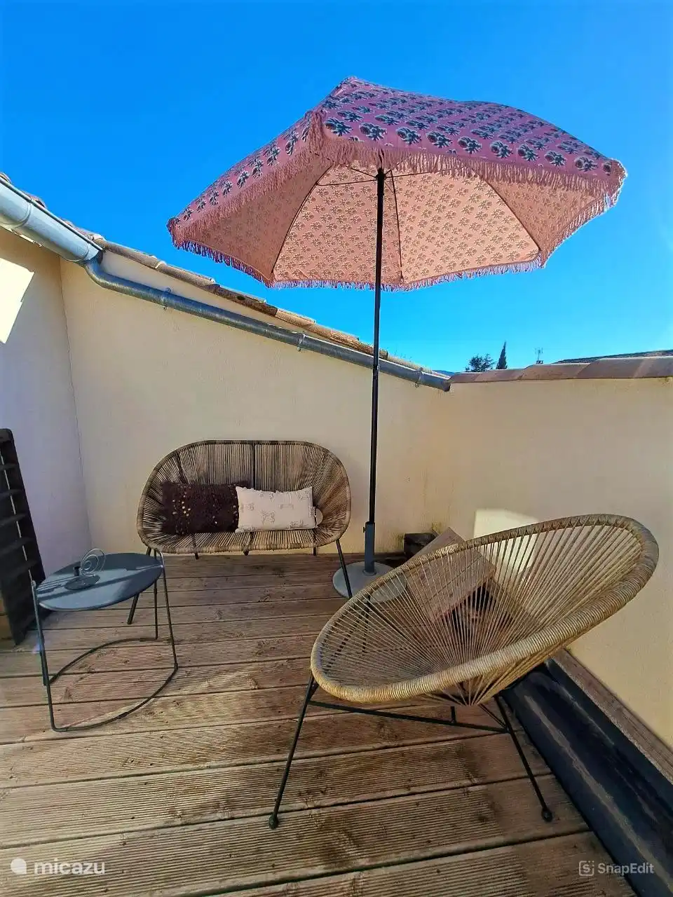 Nice private terrace with seating and dining set with parasol.