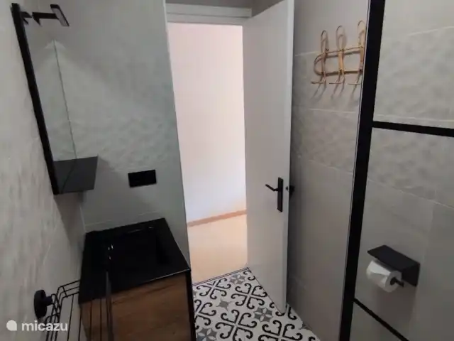 Brisa al Mar | Espagne, Costa Dorada, Salou - appartement La salle de bain dispose d’une douche à effet pluie, de toilettes suspendues et d’un lavabo avec 2 tiroirs.