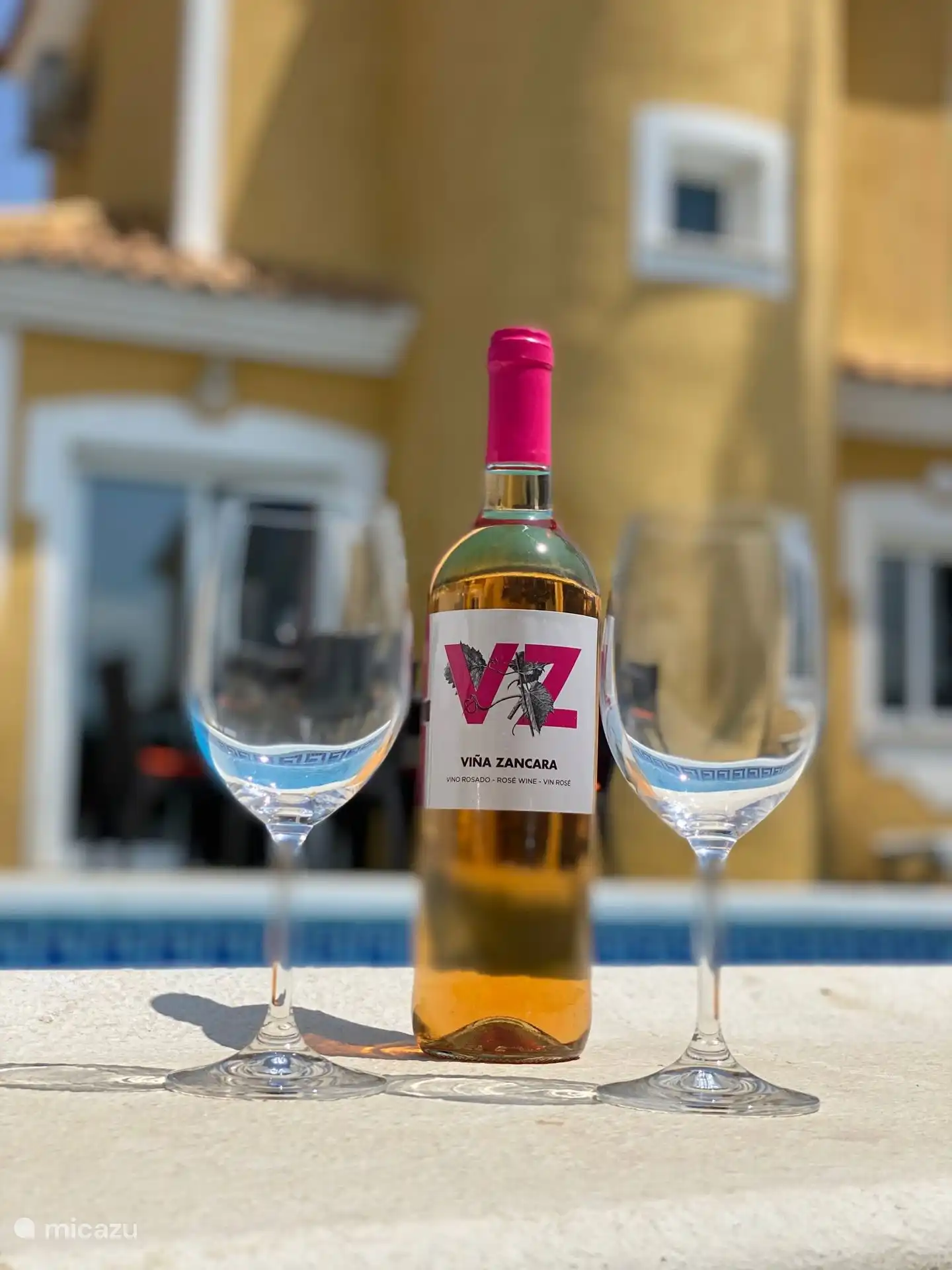 Enjoy a glass of wine by the pool