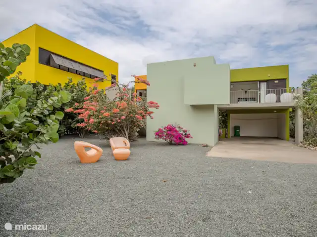 Villa design unique dans un complexe naturel | Curaçao, Curaçao-Centre, Sint Michiel - villa Vue de face de la Villa Lotus avec un grand parking sous l’abri d’auto et de l’espace pour une voiture supplémentaire.