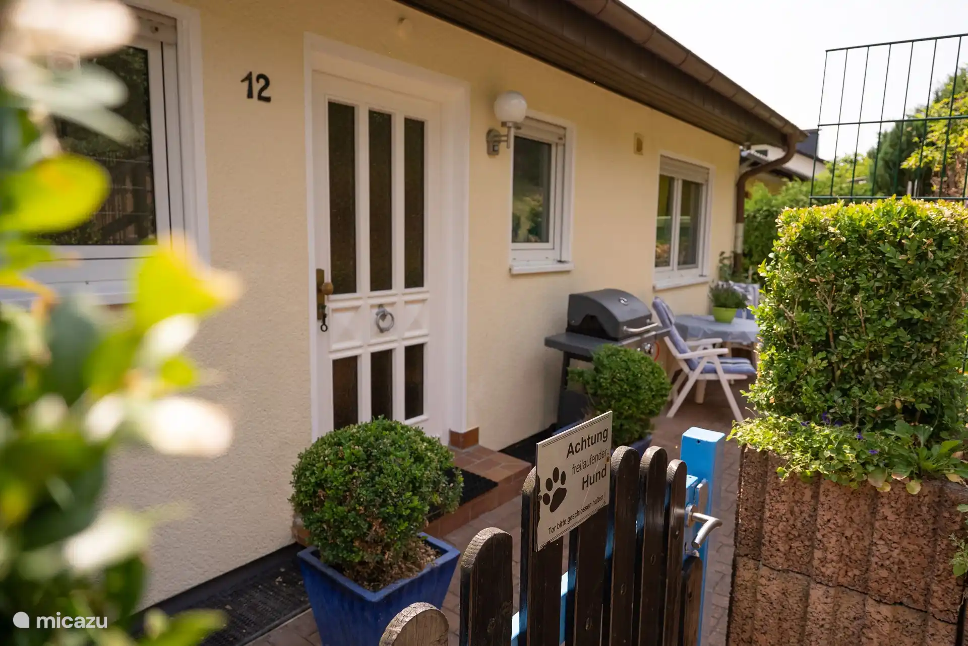 House entrance with terrace and gas grill
