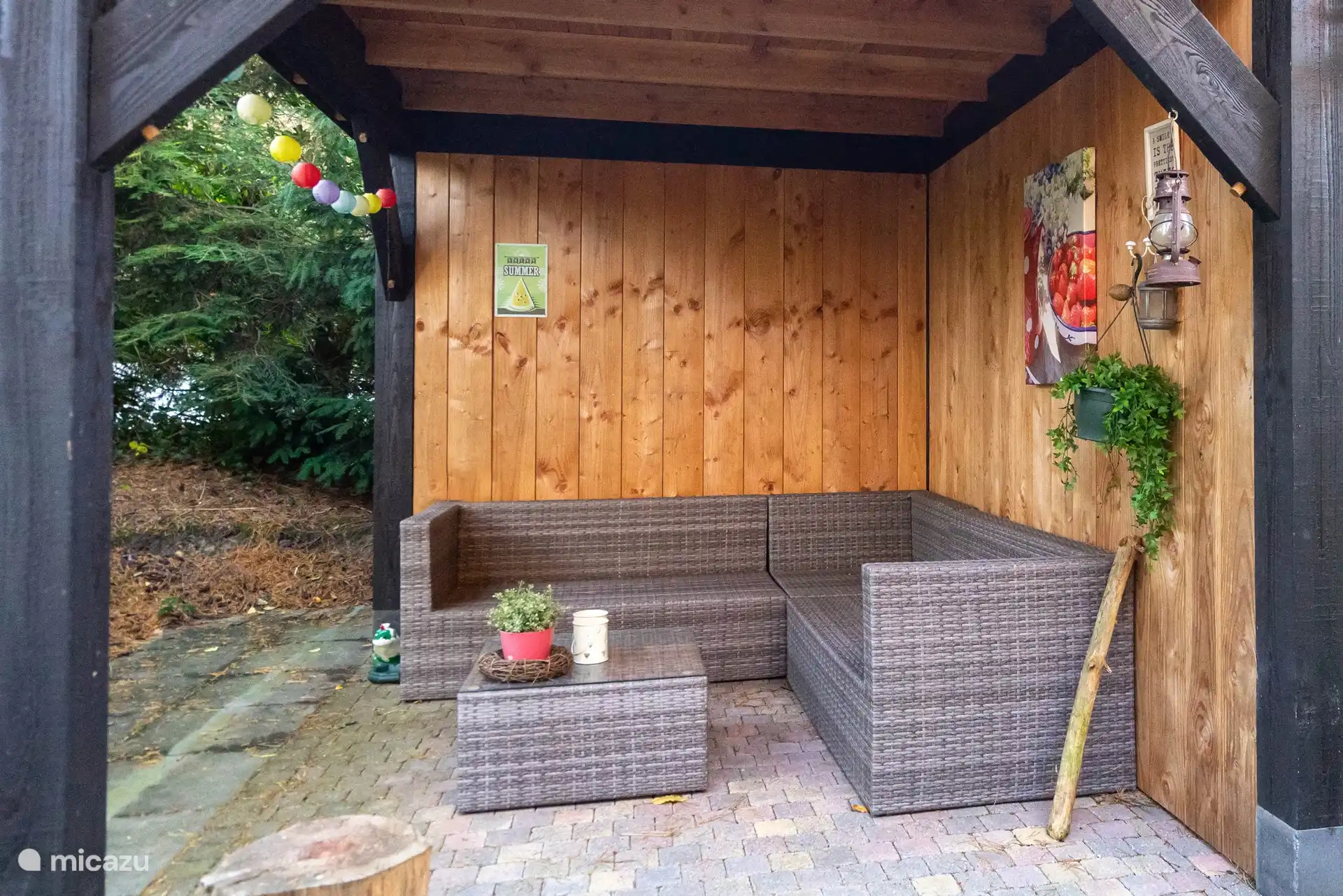 Gartenüberdachung mit Schuppen für 2 Fahrräder und einem Lounge-Set, wo Sie die Natur um sich herum genießen können