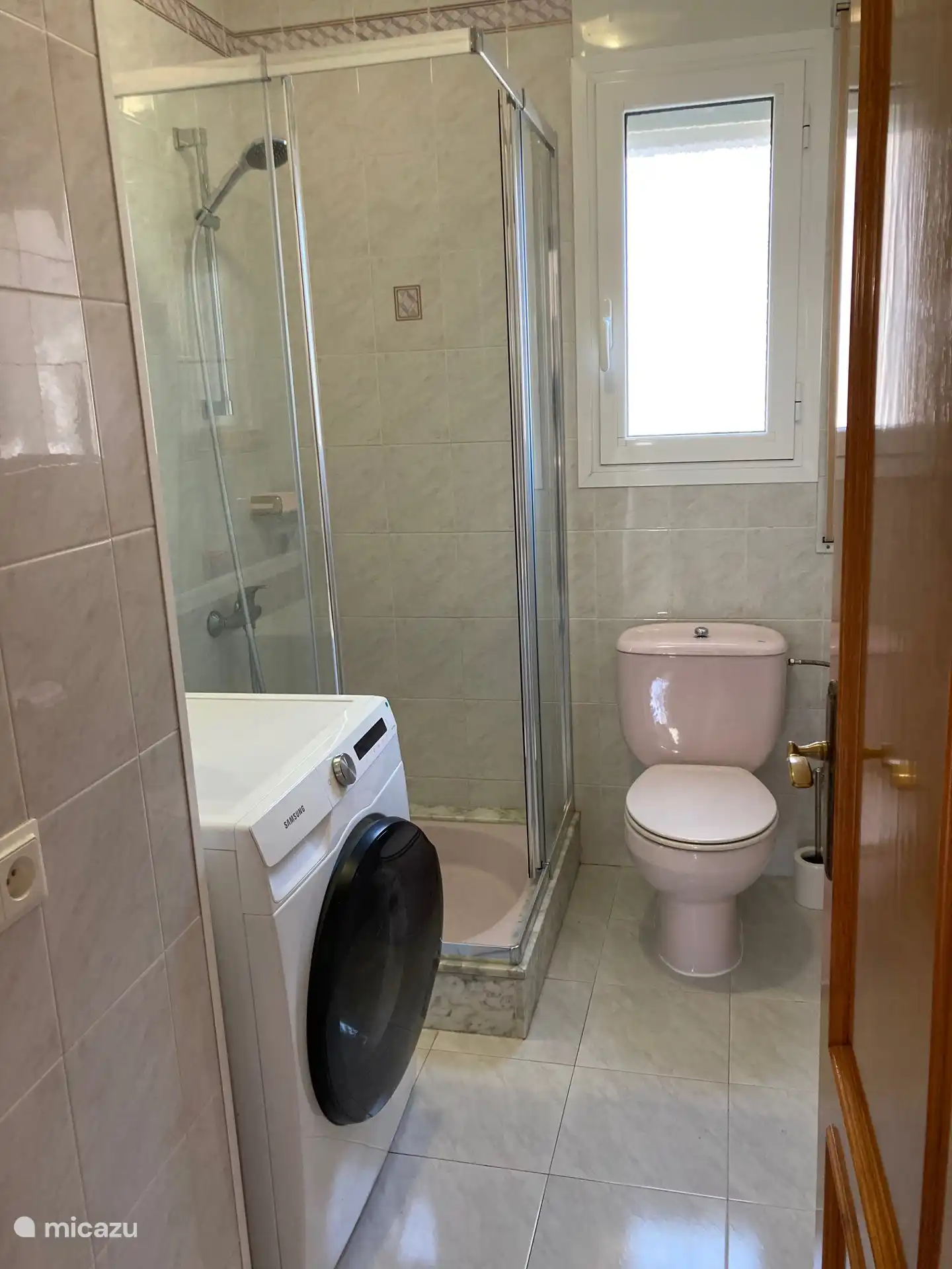 Second bathroom with shower, toilet and washing machine.