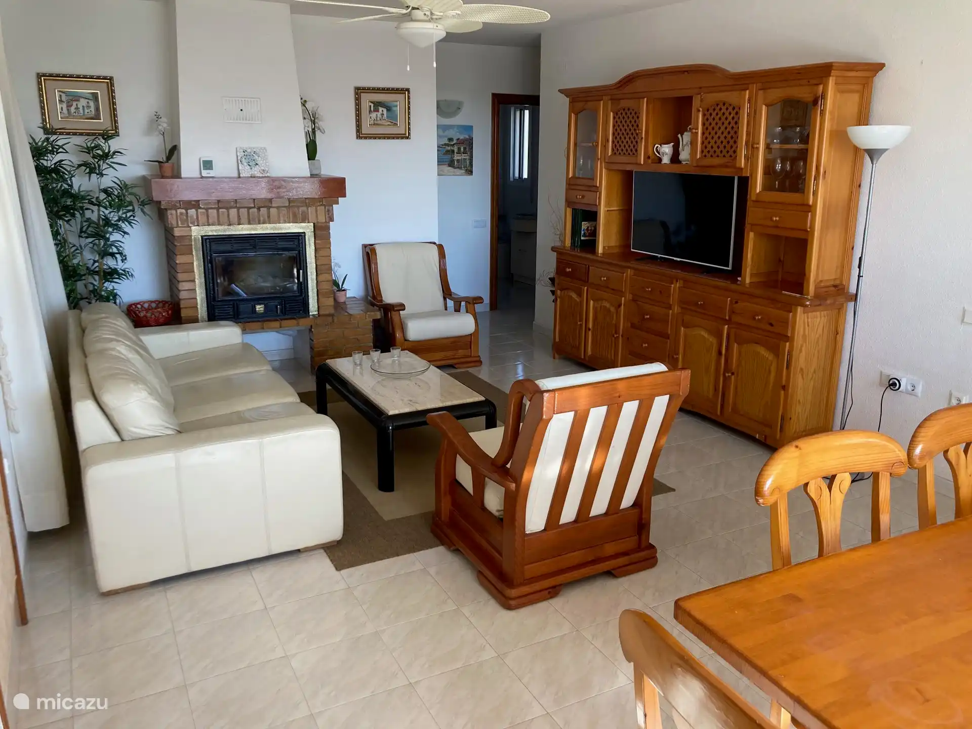 Cozy living room with sitting area, fireplace and TV.