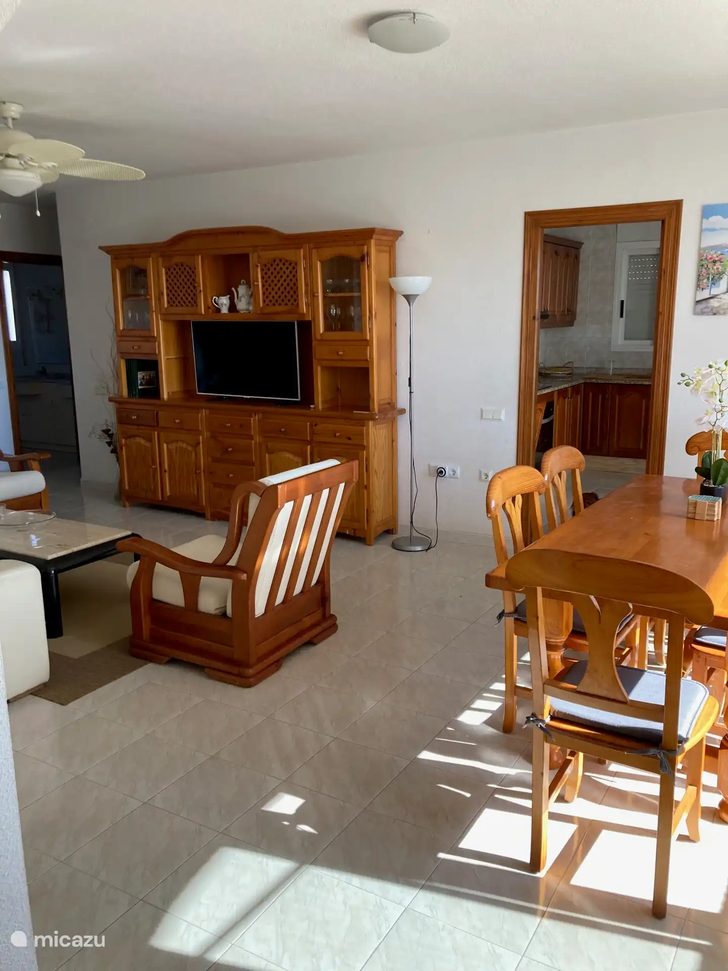 Cozy living room with dining area and patio doors to large balcony/terrace. 