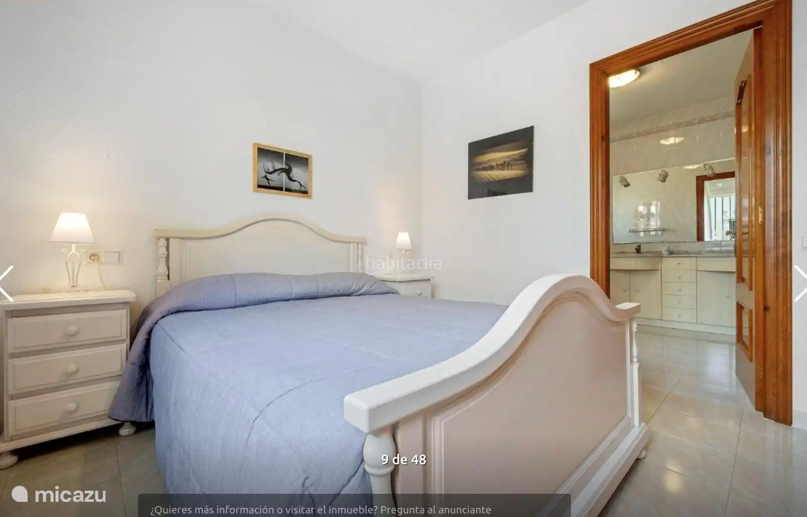 Bedroom with double bed, large built-in wardrobe and access to spacious bathroom.