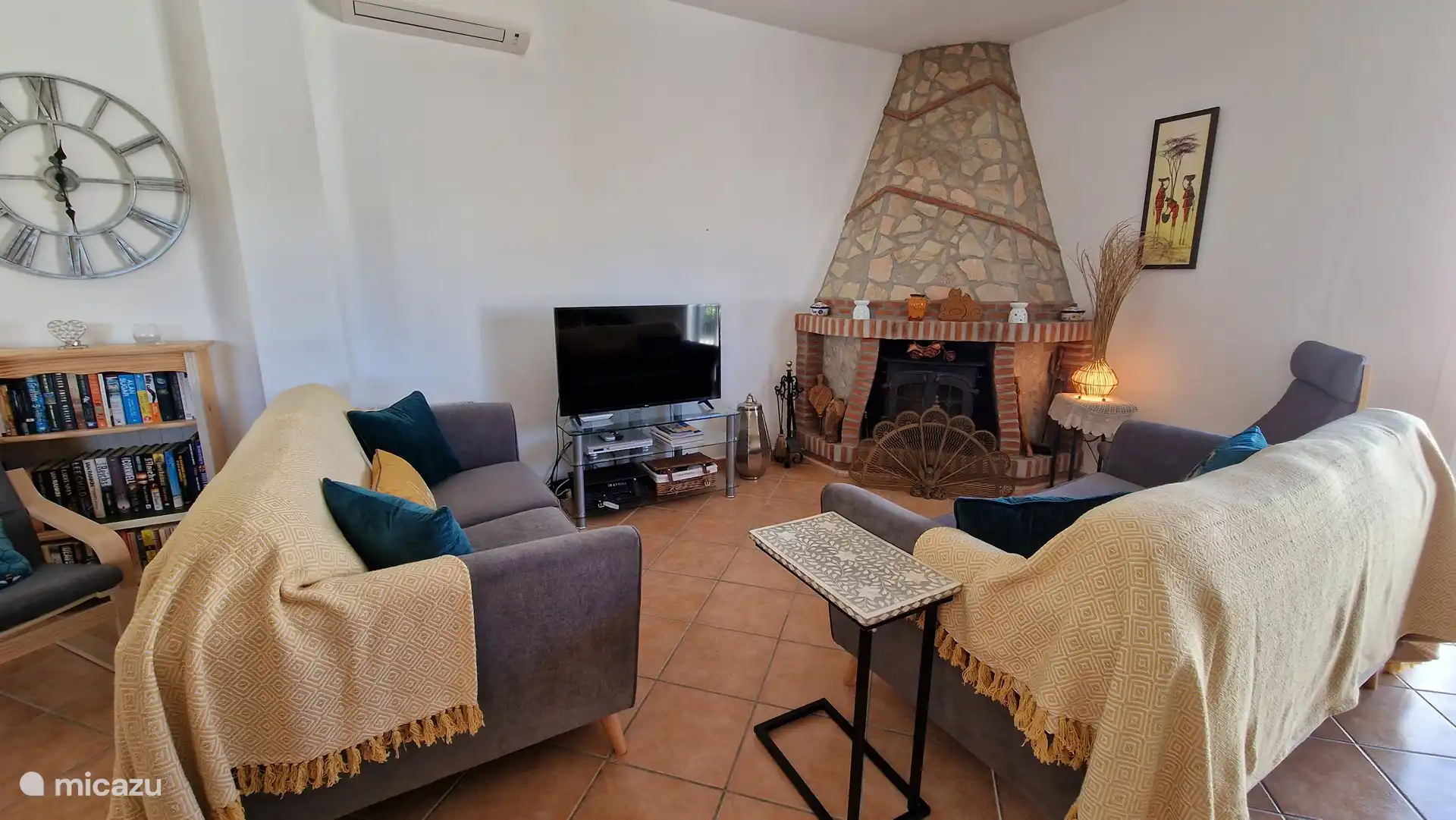 Comfortable living room. There is an aircon unit and ceiling fan in this room.