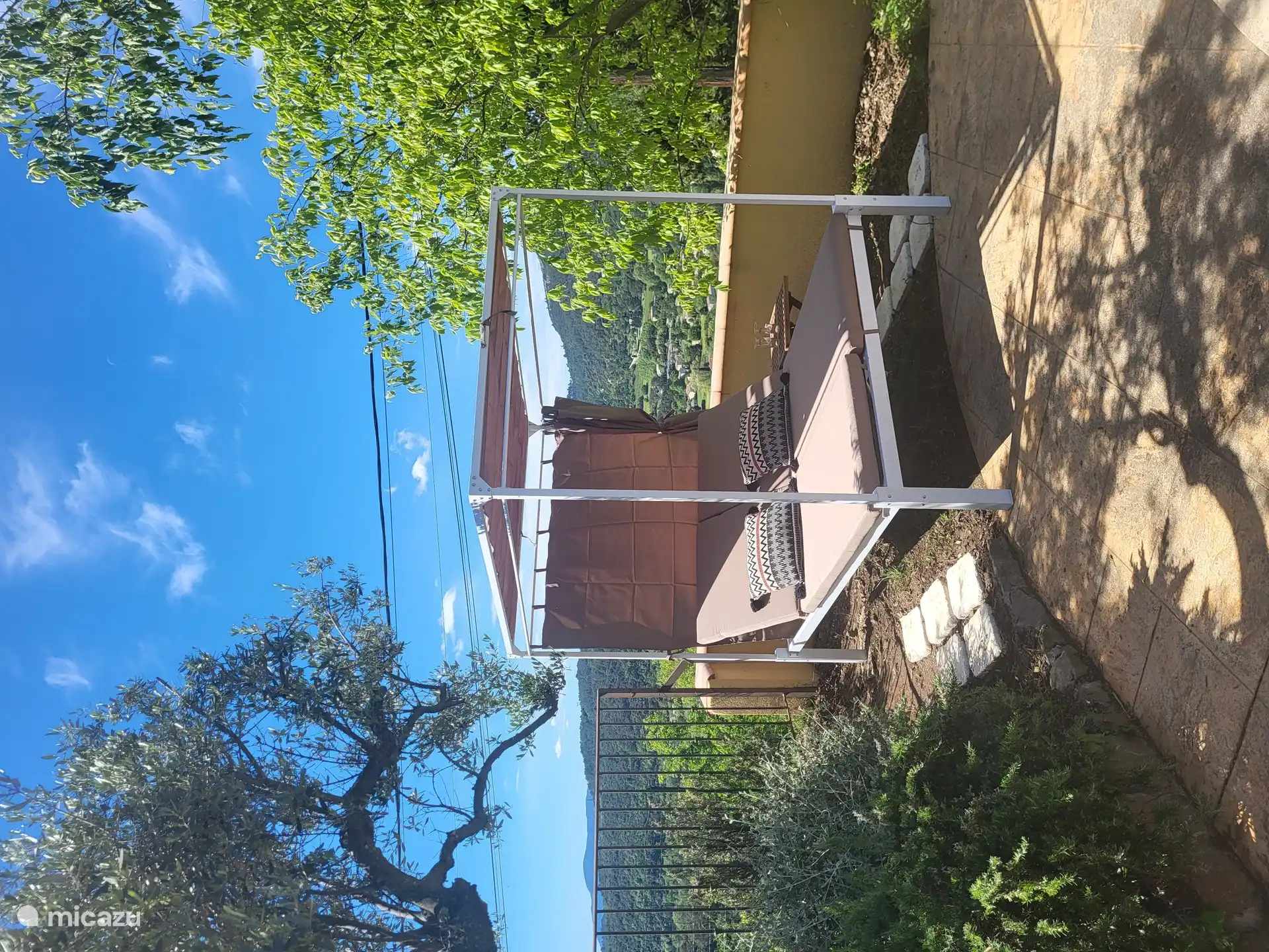 Sunbed with sun canopy by pool