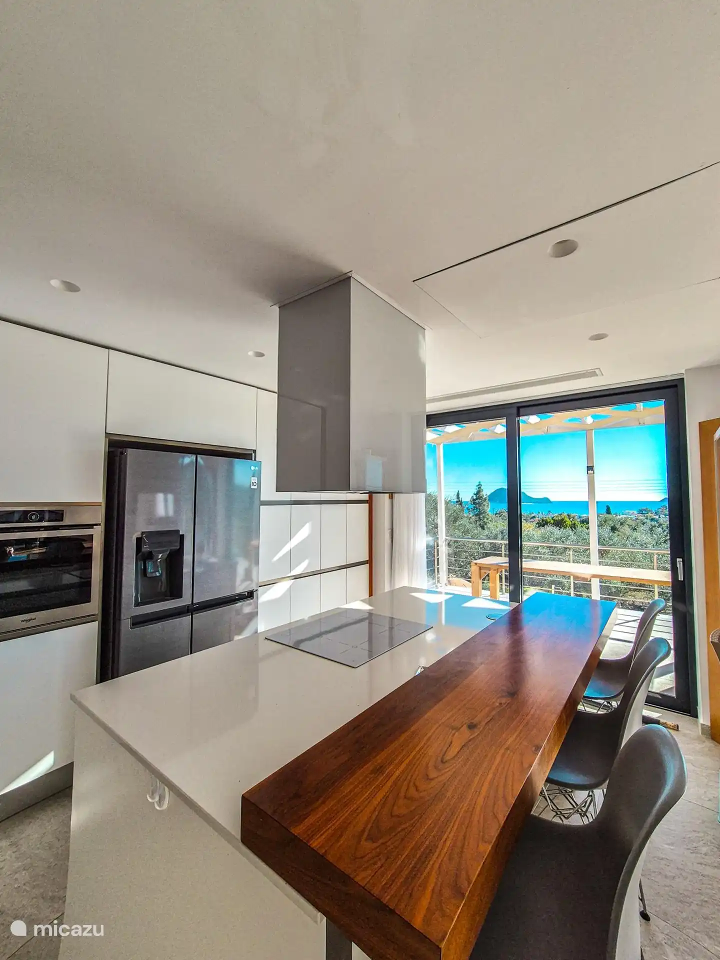 The kitchen in the house with views of the infinity pool and sea. 