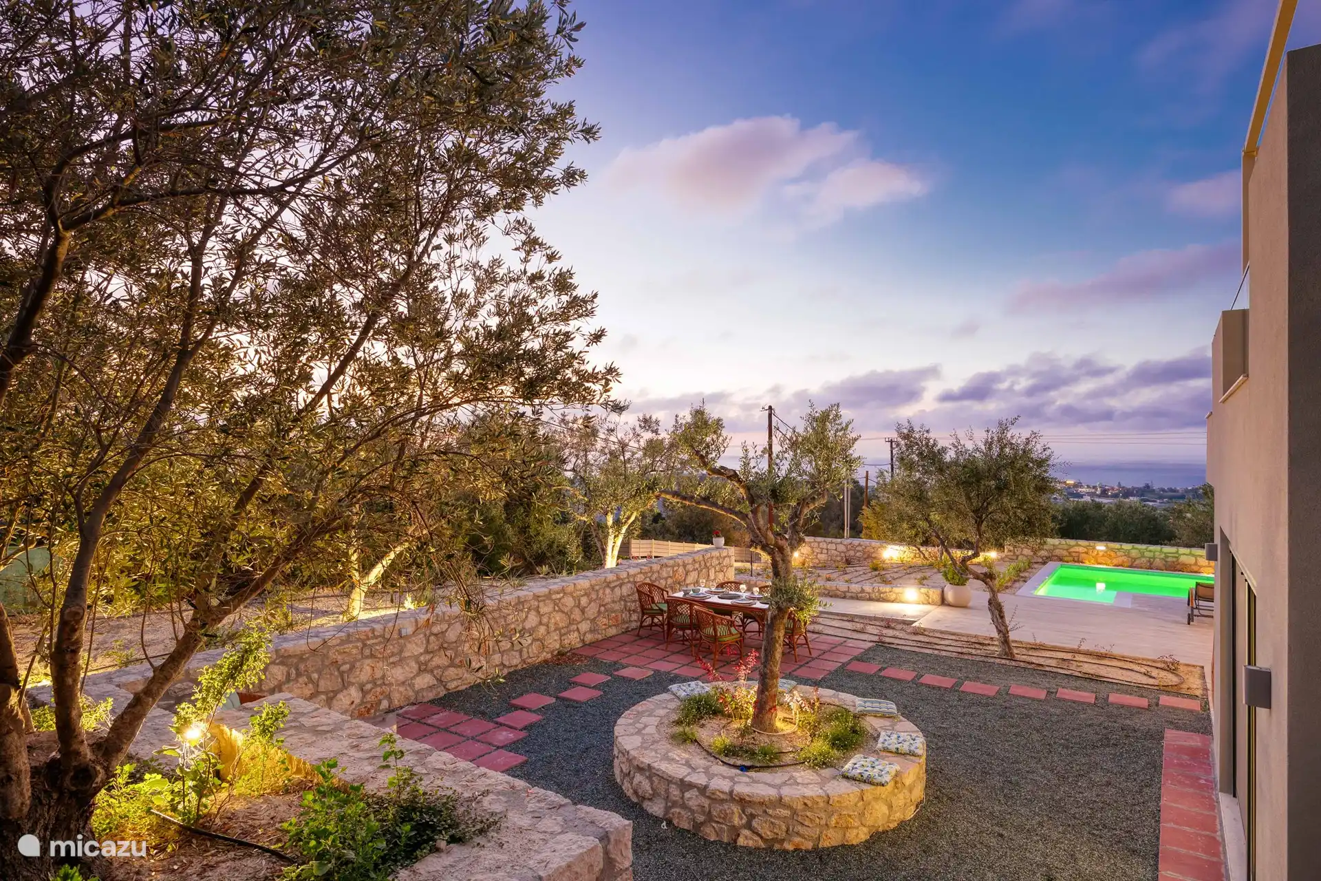 Part of the outside area with the Olive trees and the dining tablet and chairs. 