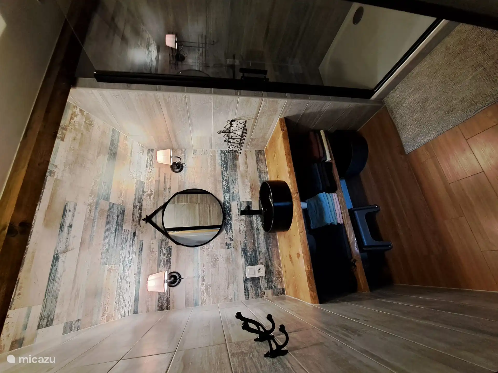 Bathroom with shower cubicle, hair dryer, towels.