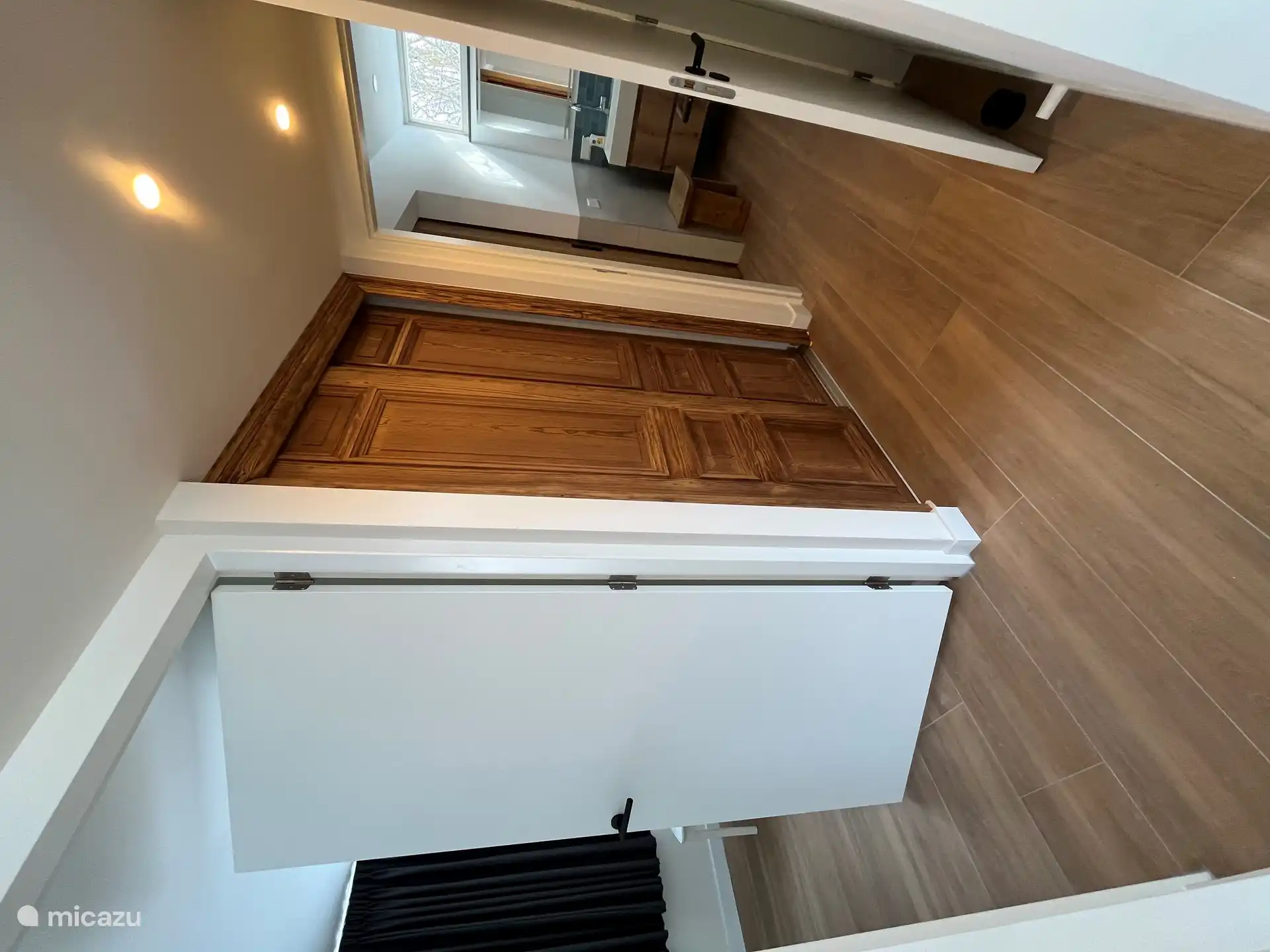 Spacious closet behind beautiful old sliding doors.
