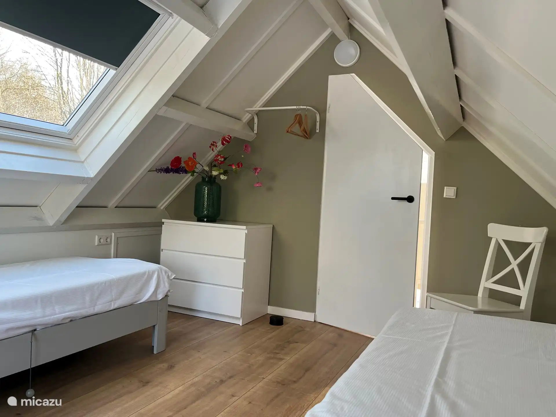 Photo of the same bedroom on the first floor with two single beds (placed separately in this photo).