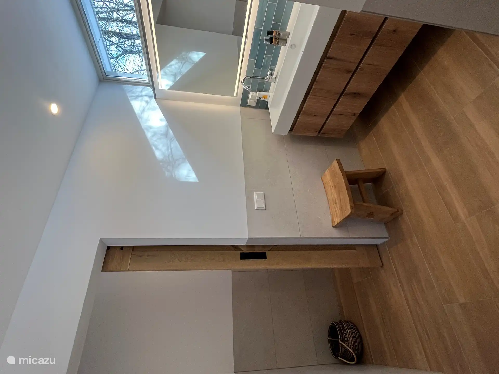 Lovely bathroom with double sink and access from the bathroom through a sliding door to a separate toilet.