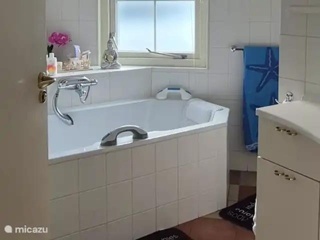 bungaló en Países Bajos, Güeldres, Putten – El lugar de Veluwe Amplio cuarto de baño no completamente renovado, pero muy cómodo, con una amplia bañera, ducha separada, inodoro y lavabo espacioso, con amplio espacio de almacenamiento para sus pertenencias personales.