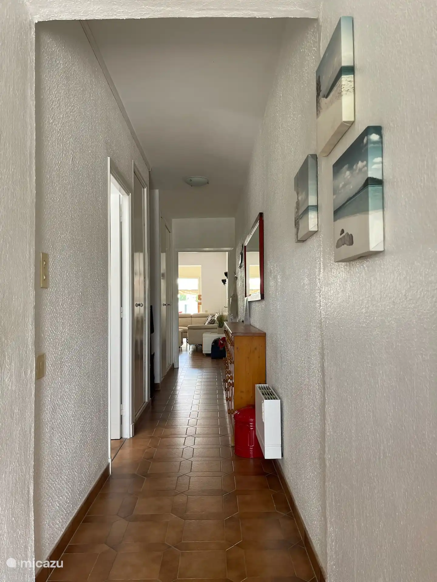 gang van de bungalow. Aan de linkerkant liggen de grote slaapkamer, kleine slaapkamer en badkamer / wc.