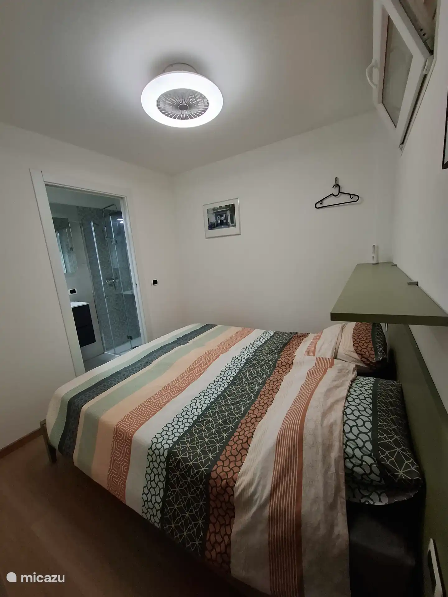 Bedroom 2, with 2 single beds. Fan above the bed.